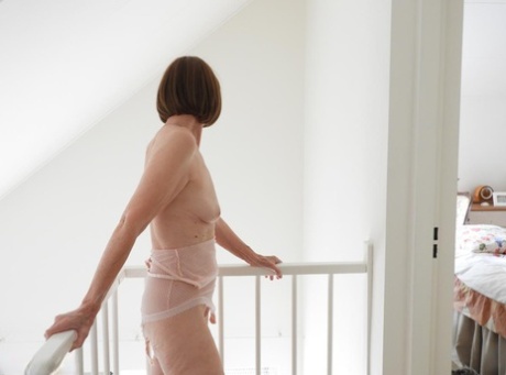 Tall granny Kat Kitty poses naked while changing her underthings