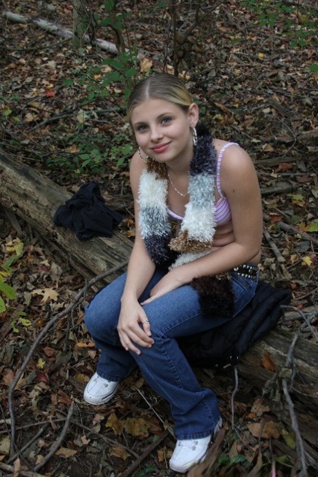 Adorable babe Lil Candy stripping in the forest and showing her puffy pussy