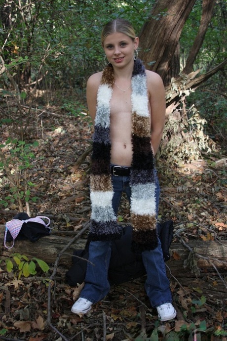 Adorable babe Lil Candy stripping in the forest and showing her puffy pussy