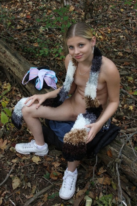 Adorable babe Lil Candy stripping in the forest and showing her puffy pussy